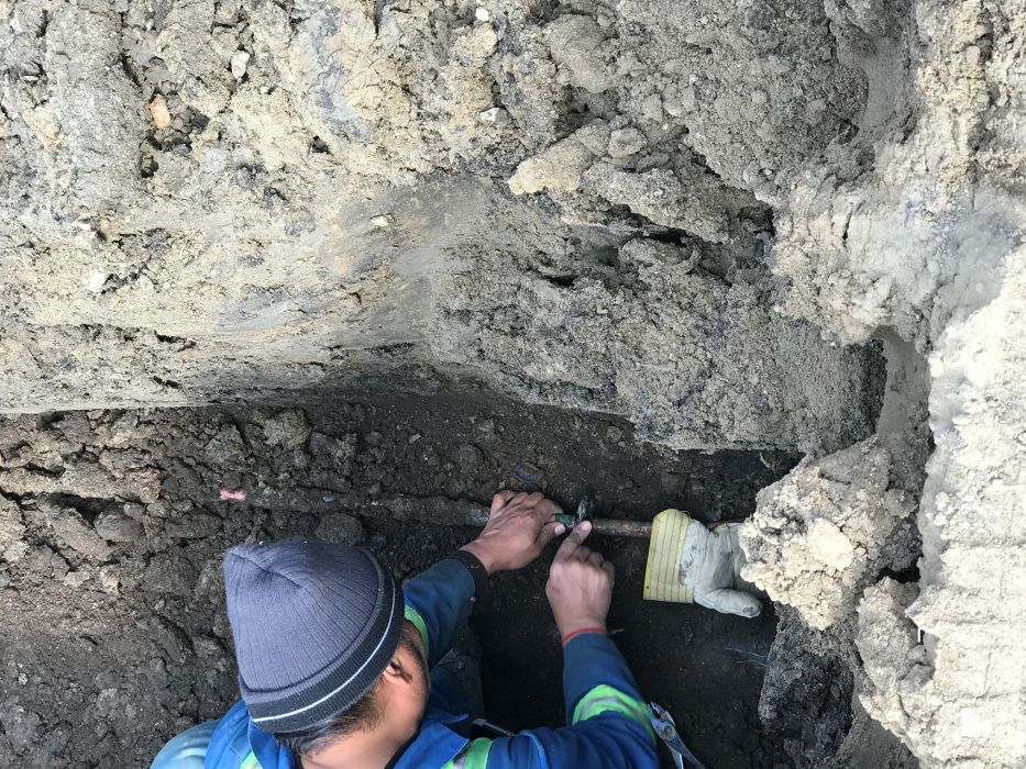 Worker performing underground utility assessment